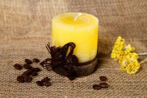 yellow pillar candle with coffee beans decoration