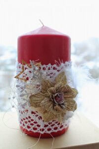 red pillar candle with decorations