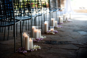 Wedding aisle decoration with pillar candles in glass