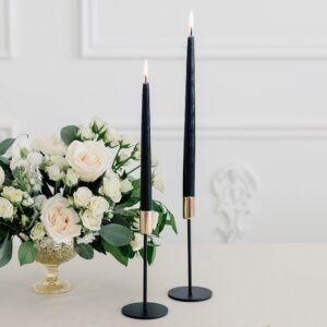 black pillar candle in candle holders 