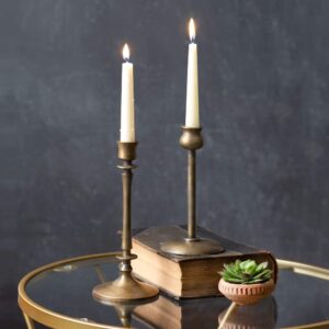 white taper candles with metal candlesticks