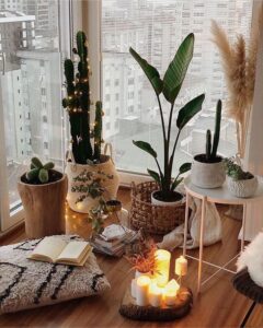 pillar candles in wooden tray with houseplants 