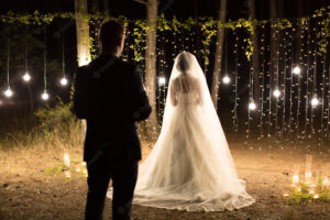 outdoor wedding ceremony with lit floating candles