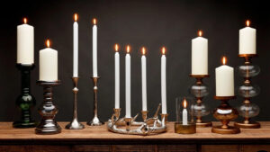 taper and pillar candles in candlesticks on table 