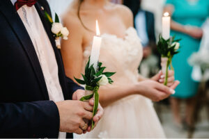 unity candle ceremony in wedding with white taper candles
