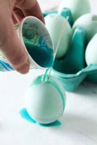 pouring candle wax in eggshell 
