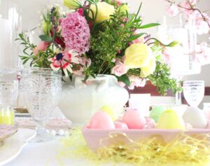 table decorated with Easter egg candles with flowers 
