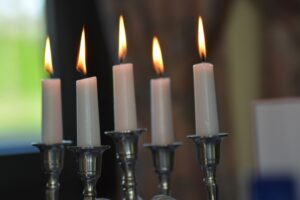 burning taper candles in candleholders 