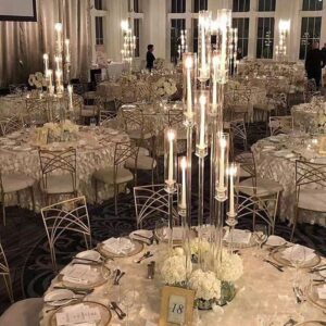 wedding tables decoration with taper candles and flowers 