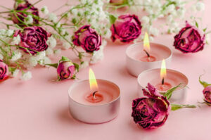 burning aroma candles and dried roses