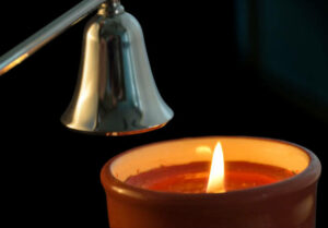 Candle about to be extinguished by a candle snuffer