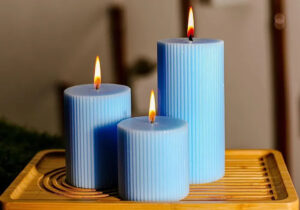 blue pillar candles on a wooden tray 