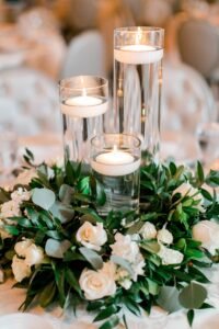 floating candles with green leaves and flowers 