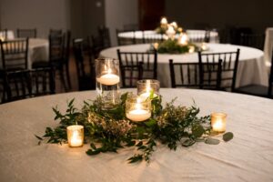 floating candles with greenery centerpieces 
