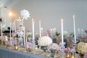 romantic wedding tablescape with elegant rose centerpieces and taper candles 