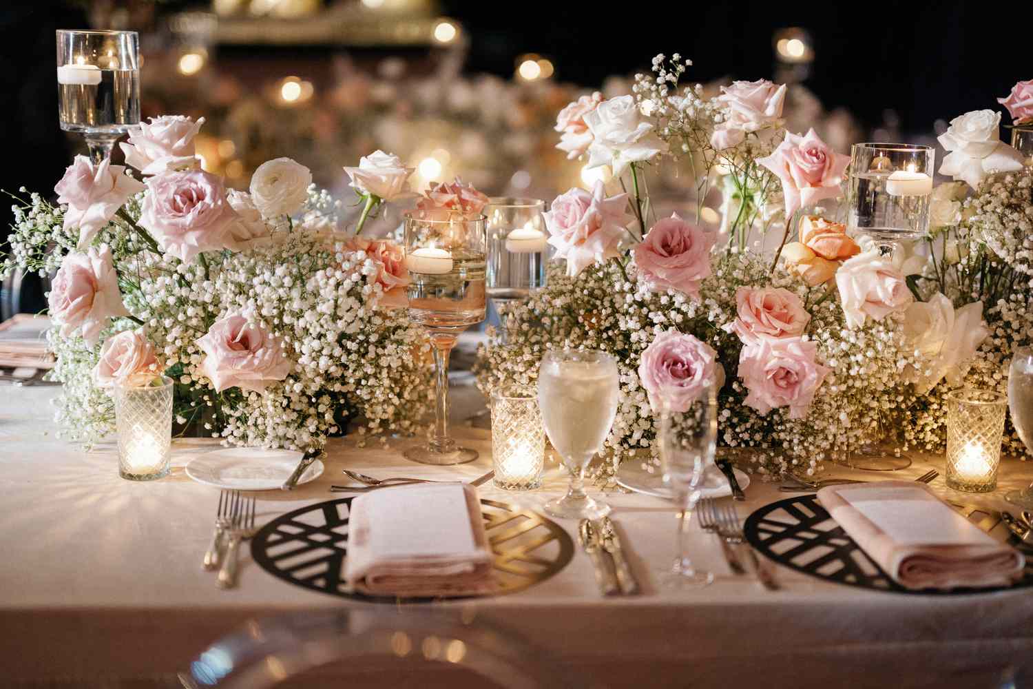 wedding table decoration with flowers and candles in jars