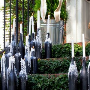 Wine bottles as candle holders for outdoor decoration 