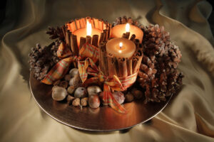cinnamon scented burning candles on a tray 