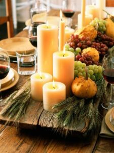burning candles with fruits on a wooden tray for Thanksgiving dinner 