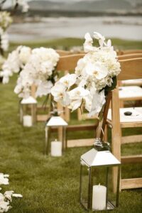 rustic outdoor lanterns with pillar candles for wedding aisle 