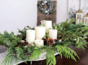 Holiday Centerpiece with pinecones, candles and greenery 