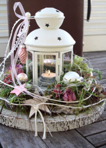 winter lantern decoration with tealight candles and flowers 