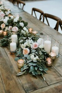 Greenery with candles for the wedding centerpiece 