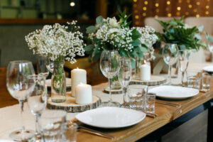 wedding table decoration with pillar candles and flowers