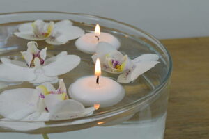 floating candles with white and purple floating orchids 